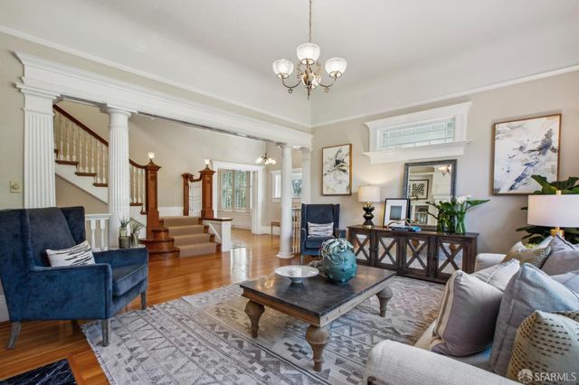 a dining room with furniture potted plants and wooden floor