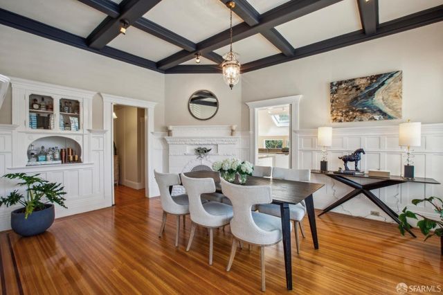 a view of a kitchen with kitchen island a large window cabinets a sink and stainless steel appliances
