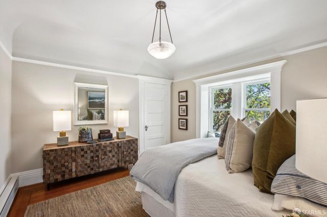 a bedroom with a bed and a lamp on table