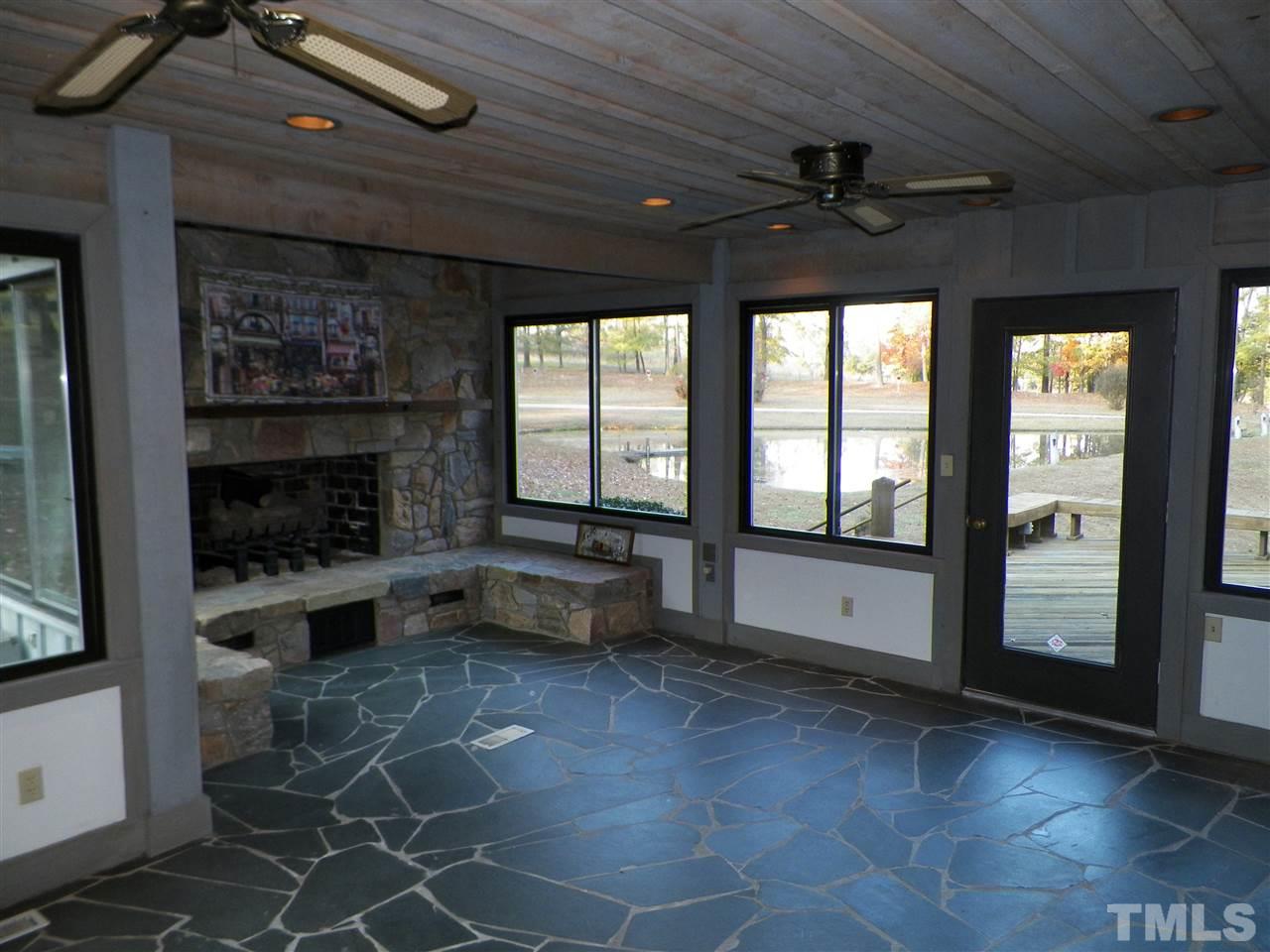 6627 Battle Bridge Road Raleigh, NC 27610 - Photo 16 of 25 a living room with furniture a flat screen tv and a fireplace