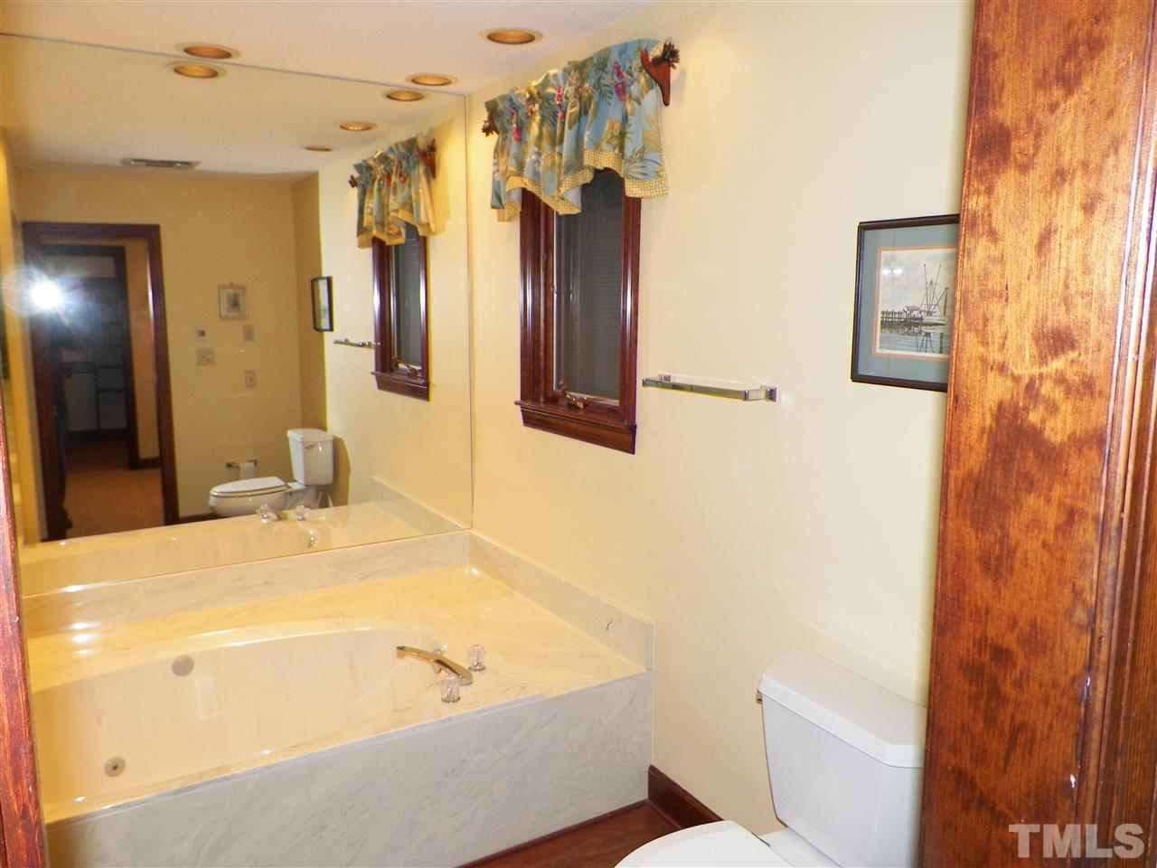 6627 Battle Bridge Road Raleigh, NC 27610 - Photo 19 of 25 a bathroom with a tub sink and shower