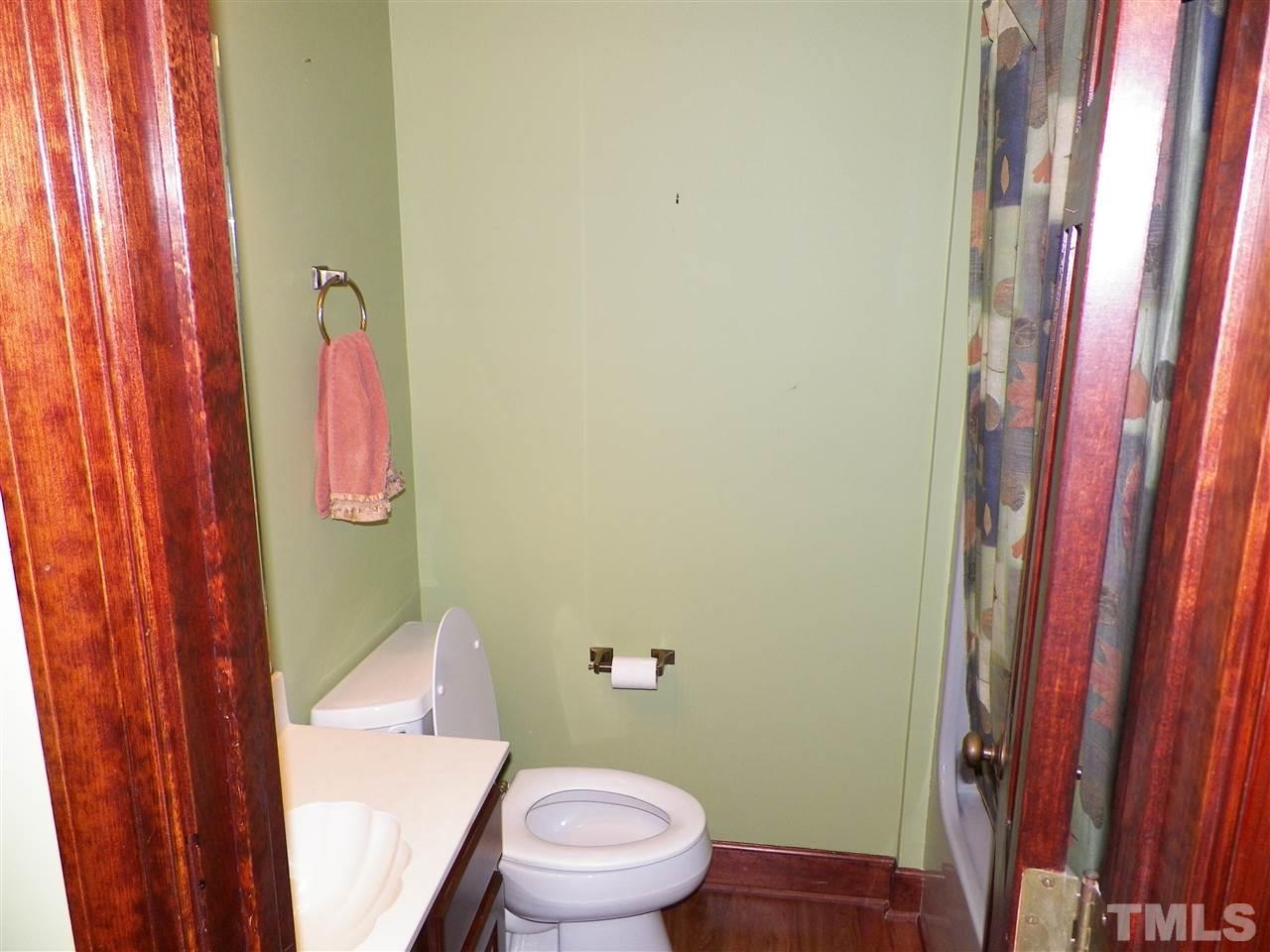 6627 Battle Bridge Road Raleigh, NC 27610 - Photo 21 of 25 a white toilet sitting next to a shower curtain