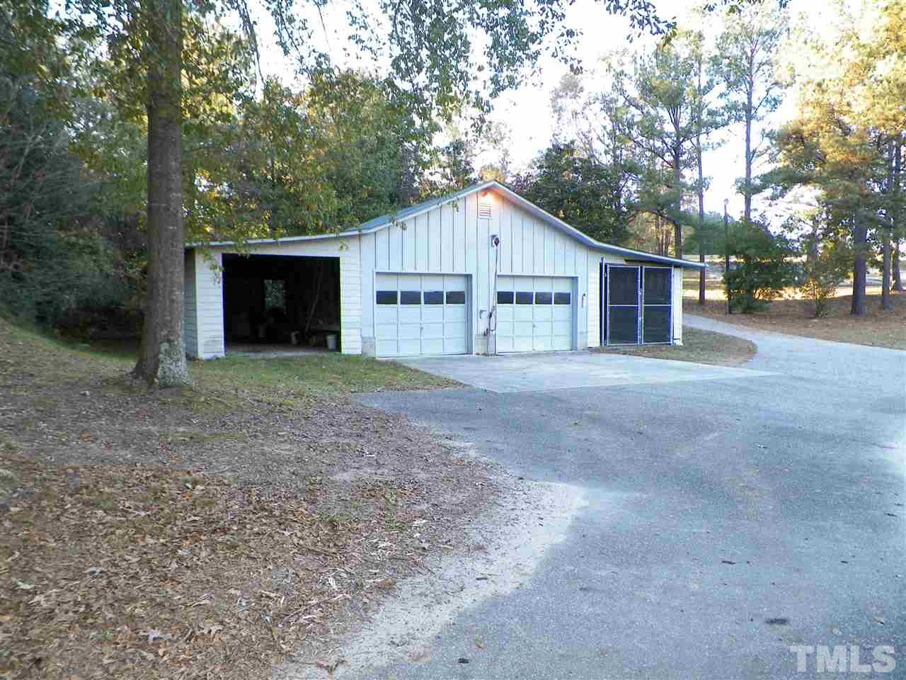 6627 Battle Bridge Road Raleigh, NC 27610 - Photo 6 of 25 a view of a house with a yard and large tree