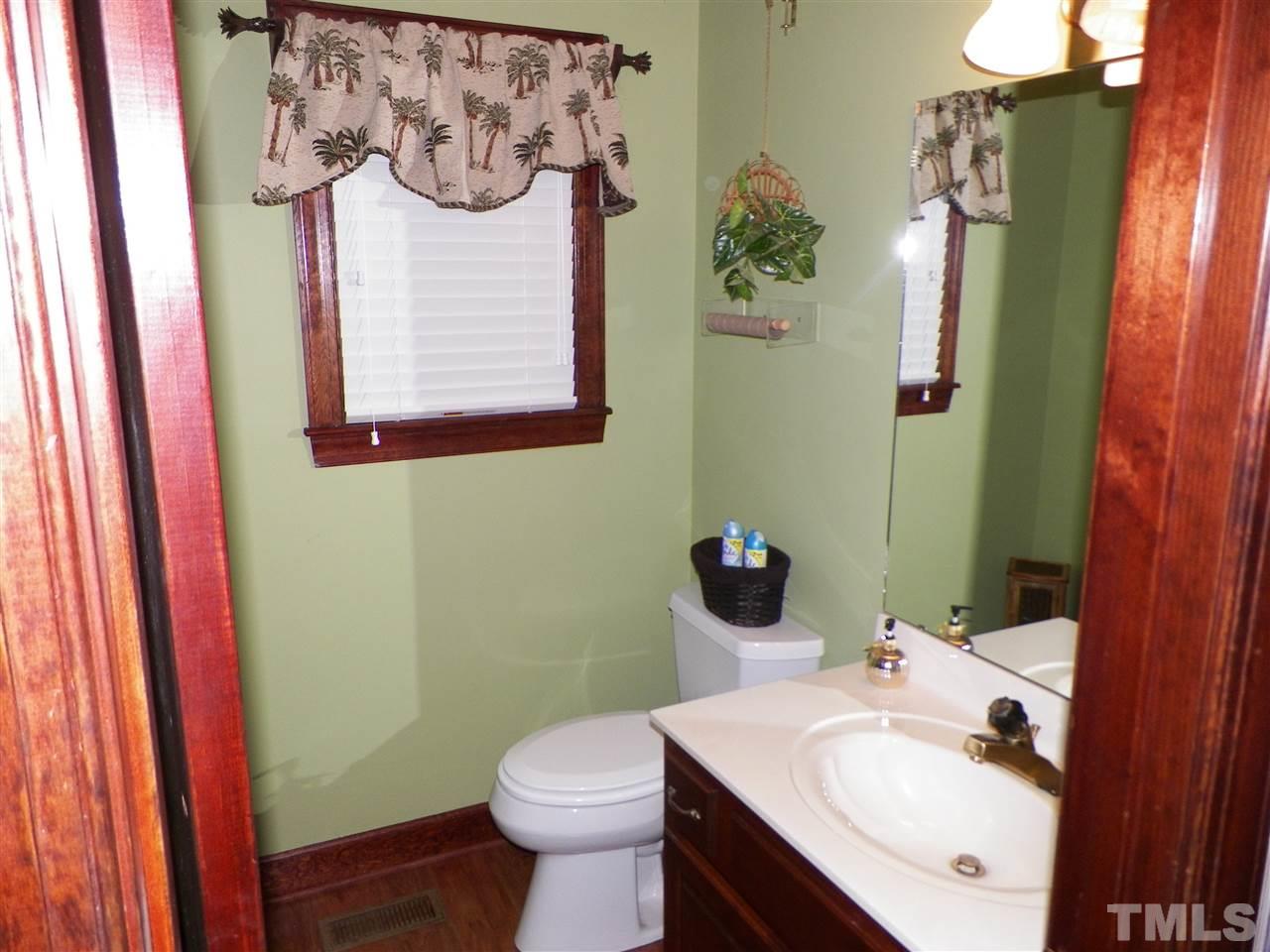 6627 Battle Bridge Road Raleigh, NC 27610 - Photo 10 of 25 a bathroom with a sink and mirror with toilet