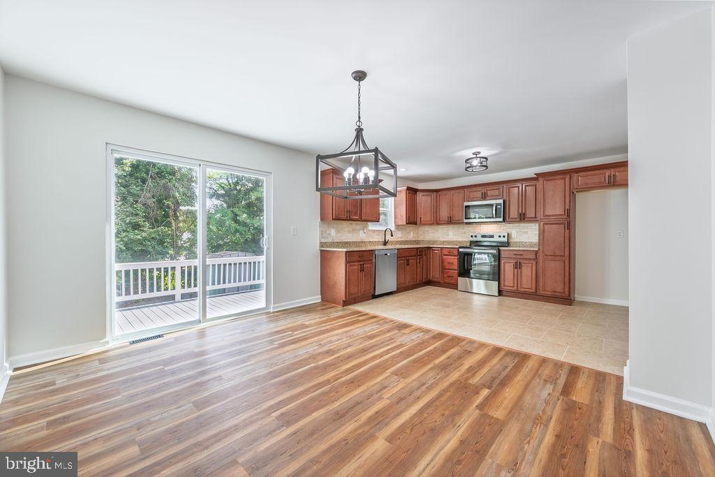 231 East Avon Road Brookhaven, PA 19015 - Photo 11 of 33 a view of a kitchen with a sink cabinet and a floor to ceiling window