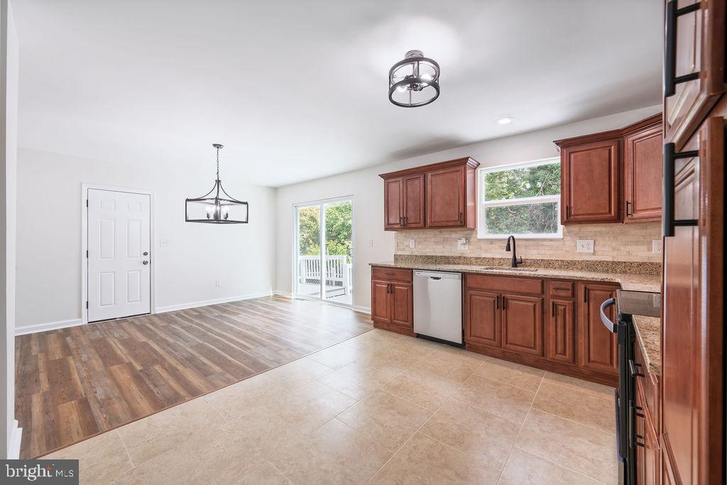 231 East Avon Road Brookhaven, PA 19015 - Photo 12 of 33 a open kitchen with kitchen island granite countertop a sink cabinets and window