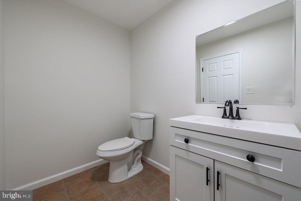 231 East Avon Road Brookhaven, PA 19015 - Photo 16 of 33 a bathroom with a sink a toilet and a mirror
