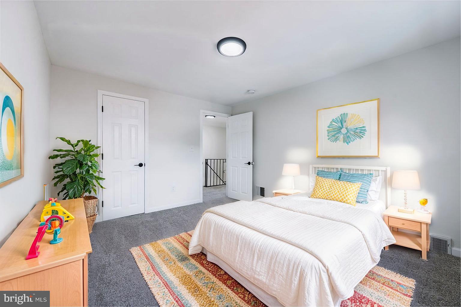 231 East Avon Road Brookhaven, PA 19015 - Photo 21 of 33 a bedroom with a bed and a painting on the wall