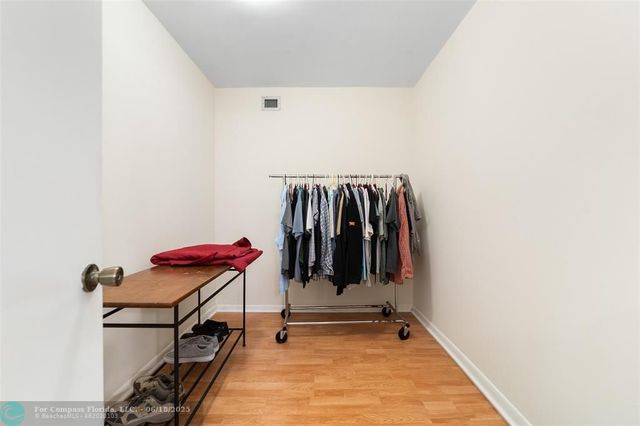 a view of walk in closet with clothes