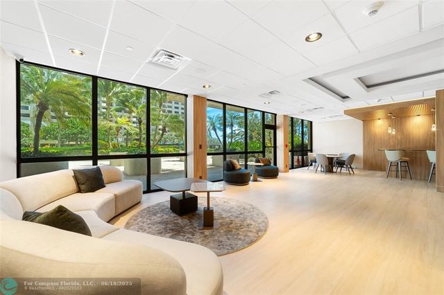 a large bedroom with furniture and large windows