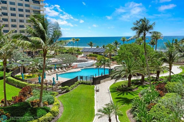 a view of swimming pool patio and lake view