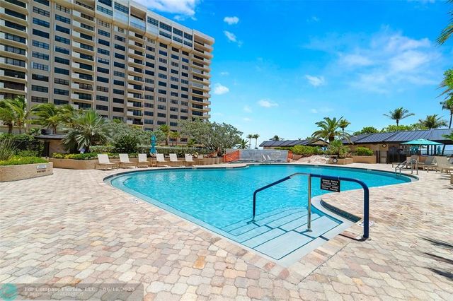 a view of swimming pool with outdoor seating