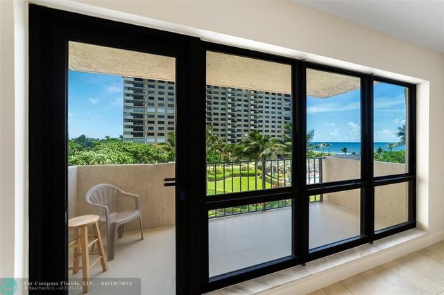 a view of a glass door with a balcony