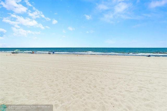 a view of a kitchen with kitchen island a large window in it