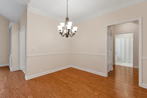 a kitchen with stainless steel appliances granite countertop a sink a stove and a wooden floors