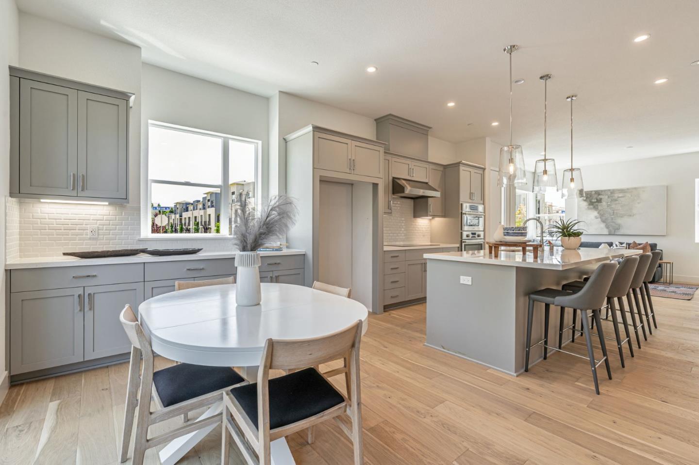 522 Lapis Court San Ramon, CA 94583 - Photo 7 of 23 a kitchen with kitchen island a dining table chairs sink and cabinets