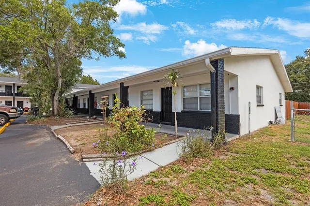 a front view of house with yard outdoor seating and barbeque oven