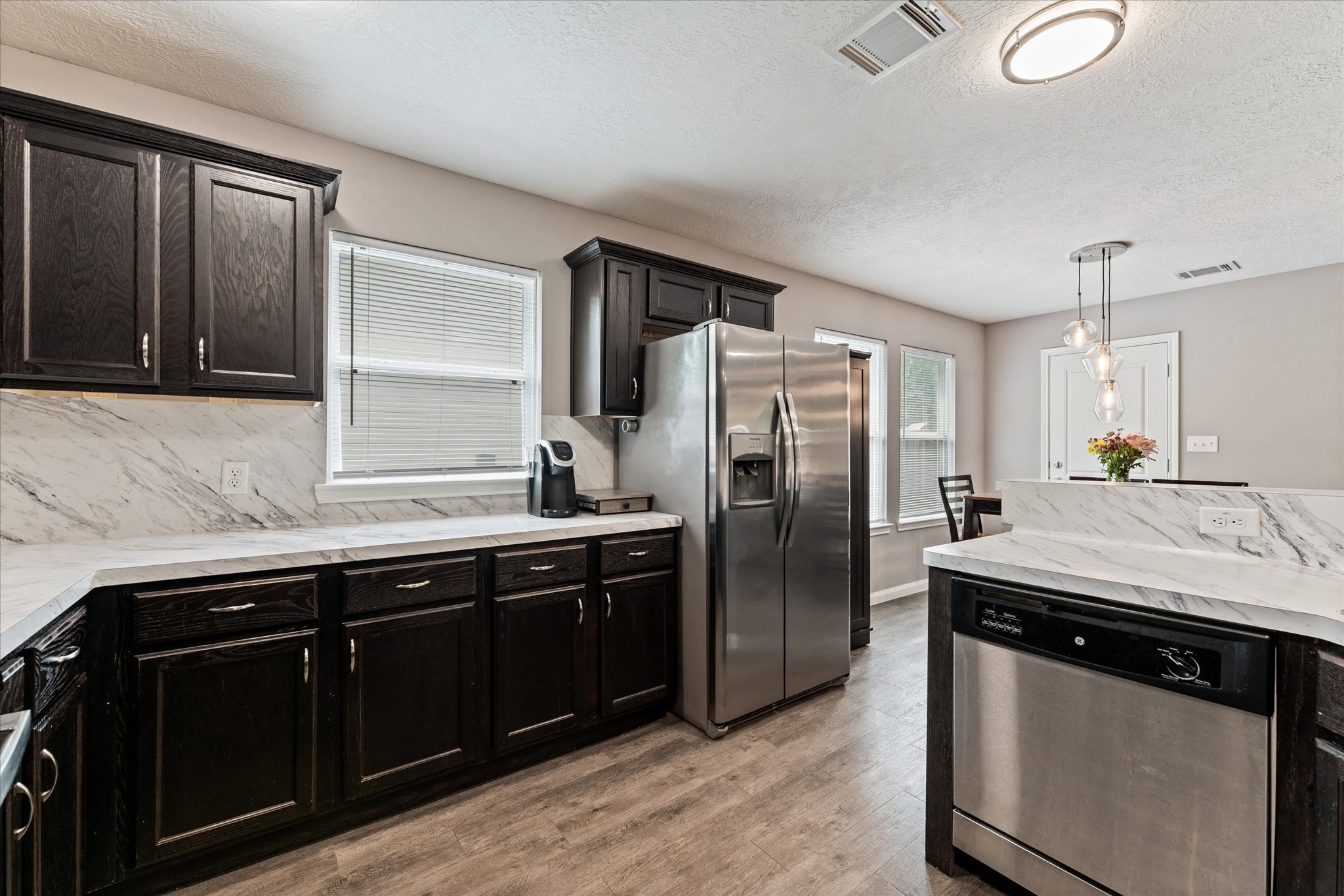 3998 Frontier Road Willis, TX 77378 - Photo 23 of 33 a kitchen with stainless steel appliances granite countertop a sink stove and refrigerator