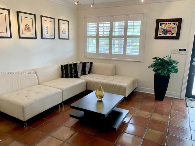 a living room with furniture and a potted plant