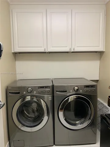 a utility room with sink dryer and washer