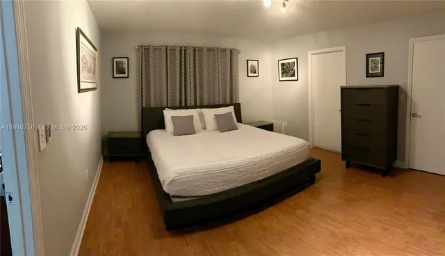 a bedroom with a bed and dresser