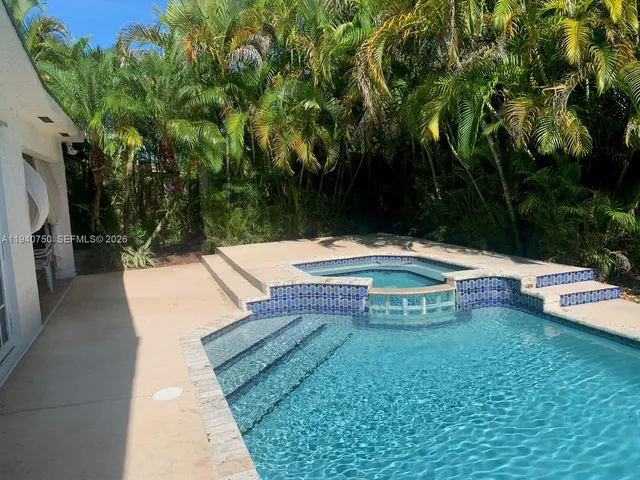 a backyard of a house with table and chairs