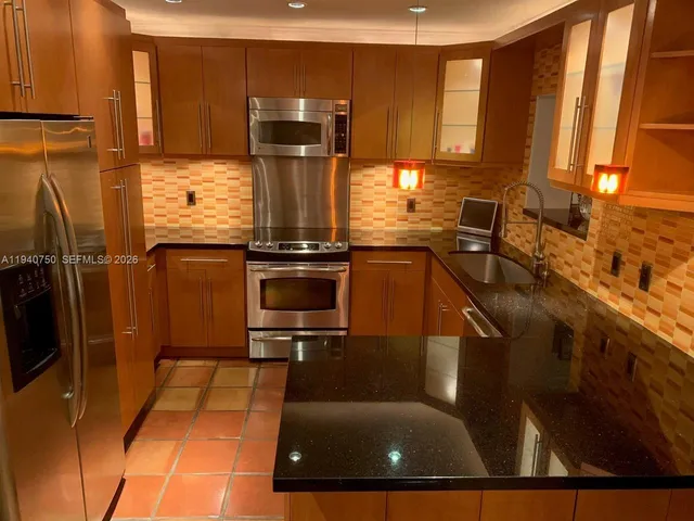 a kitchen with a sink cabinets and appliances