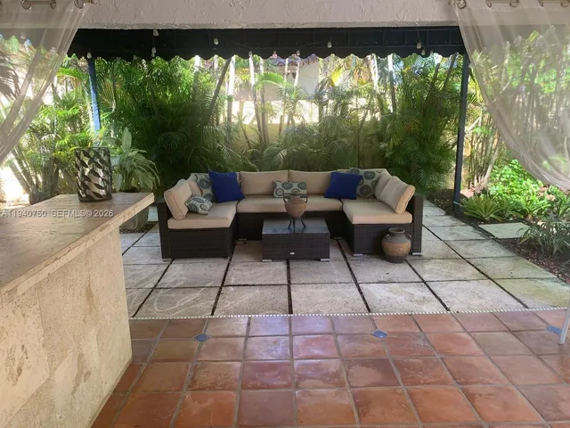 a view of a patio with couches and table with garden