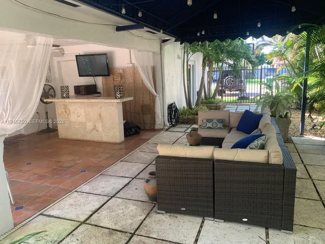 a living room with furniture and a flat screen tv