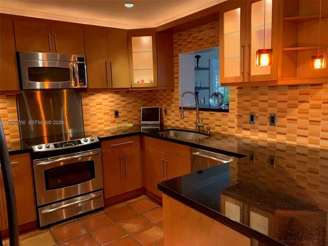 a kitchen with a sink stove and microwave