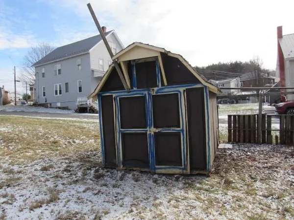 a view of a house with a wooden fence