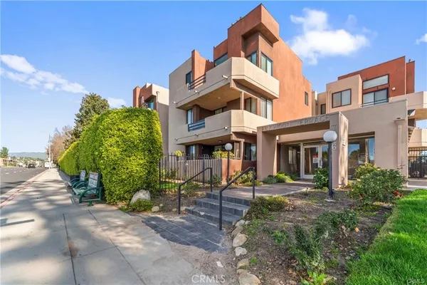 a front view of a building with garden