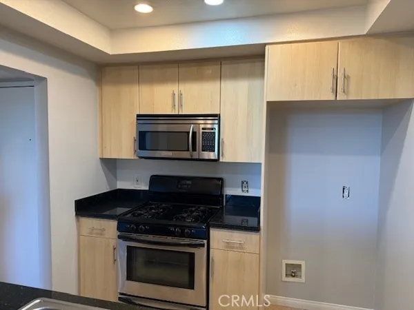 a kitchen with a stove and a microwave