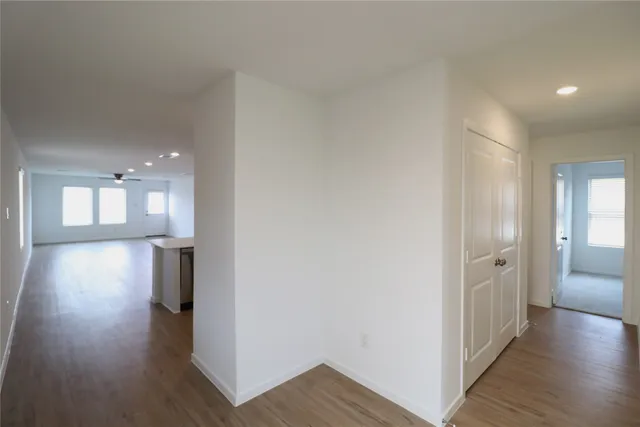 a view of hallway with wooden floor