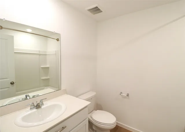 a bathroom with a sink a toilet and mirror