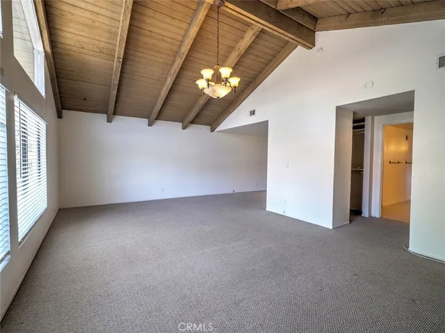 a view of a livingroom with an empty space and a window