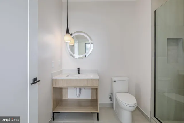 a bathroom with a toilet sink and mirror
