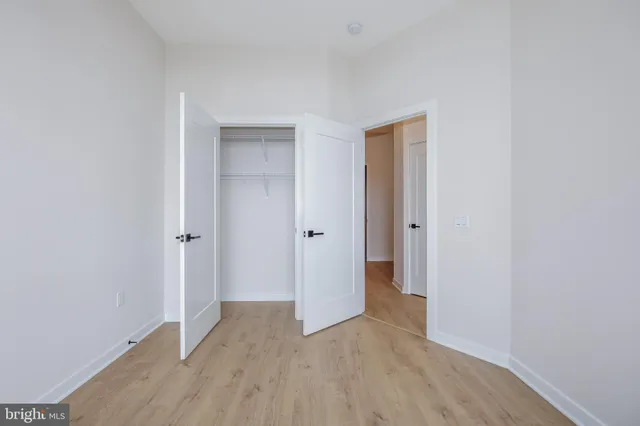 a view of hallway with wooden floor