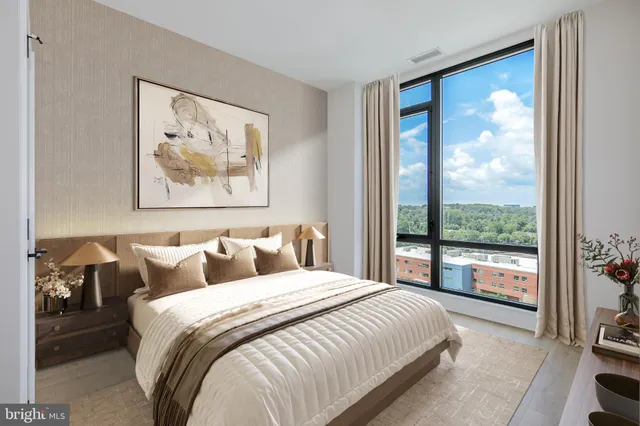 a bedroom with a large bed and a large window with outer view