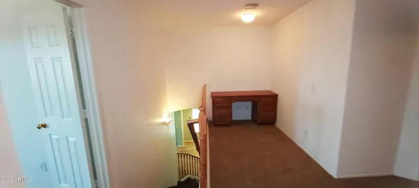a view of a big room with closet and a chandelier fan