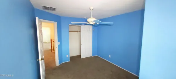 view of a room with a refrigerator and mirror