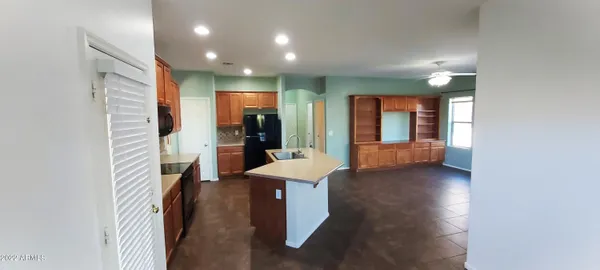 a kitchen with stainless steel appliances granite countertop a sink a stove and a refrigerator