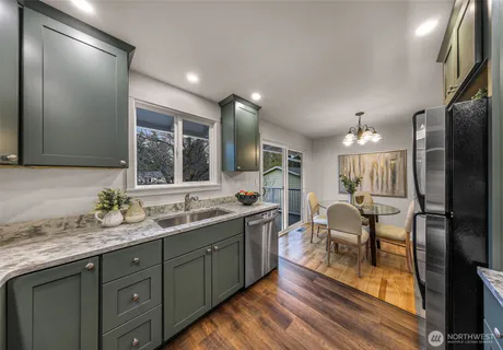 a bathroom with a sink double vanity granite and a refrigerator
