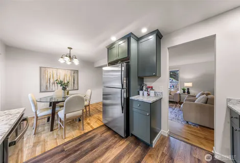 a living room with furniture and kitchen view