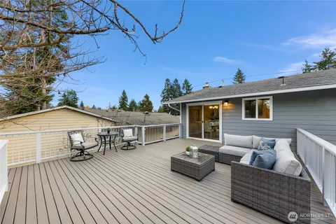 a view of a roof deck with couches and potted plants