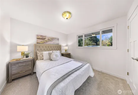 a bedroom with a bed and a painting on the wall