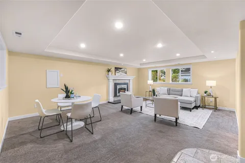 a living room with fireplace furniture and a wooden floor