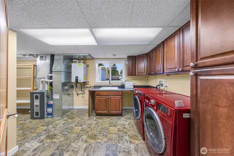 a kitchen with refrigerator sink washer and cabinets