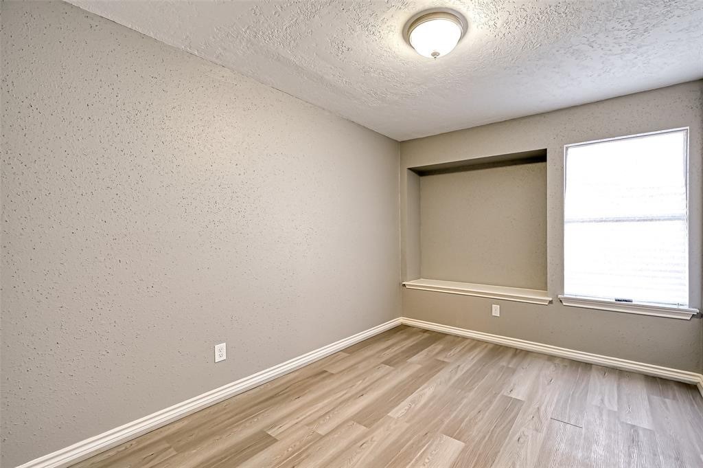 10252 Cottage Field Road Houston, TX 77041 - Photo 13 of 18 an empty room with wooden floor and windows