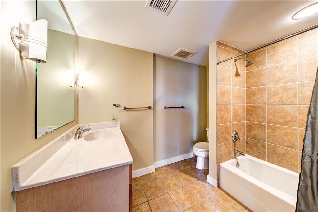 711 West 26th Street, Unit 506 Austin, TX 78705 - Photo 12 of 16 a bathroom with a sink a toilet a tub and shower